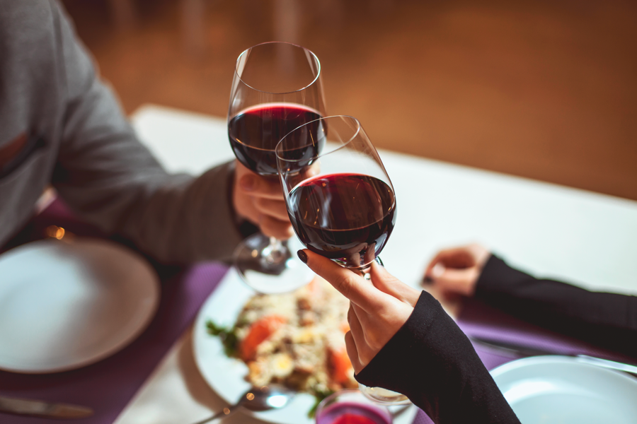 People toasting with red wine at Red Fox Supper Club in Helena, Montana.